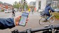 A Hand holding a smartphone with navigation app.